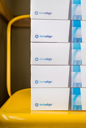 five boxes of Invisalign on a yellow chair